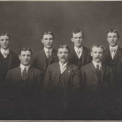 7 men dressed in suits - Talbert
