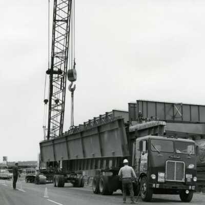 Workers with Truck Transporting Steel Girders, I-205 Bridge Construction.