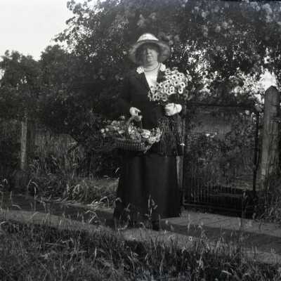 Lou Cochran in Yard with Flowers.