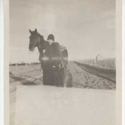 Woman Holding Reins of Horse