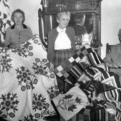 Georgia Farmer and Ladies with Clackamas County Historical Society Quilts.