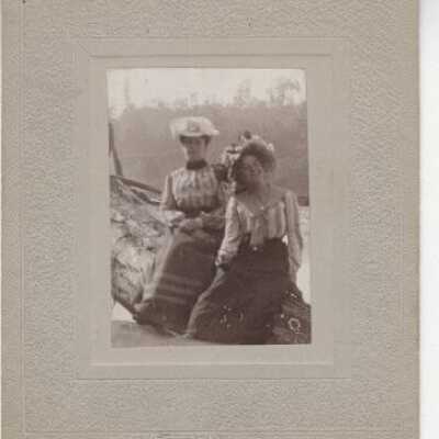 Minerva Thiessen and Mildred Gower on log overlooking the Willamette River Falls, Oergon - 1900