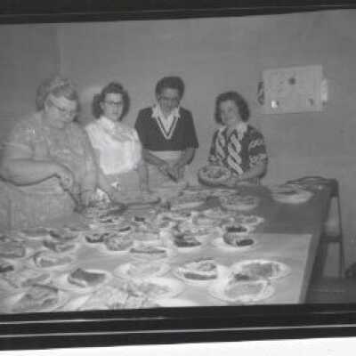 4 Women at table full of pies