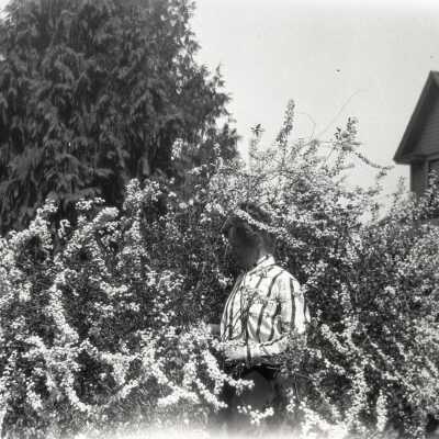 Man in Front Yard of House.