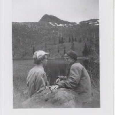 Women sitting by a rock