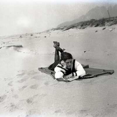 Girl Laying on Blanket at Beach.