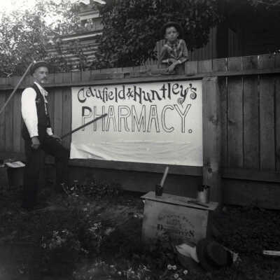 Painting of Caufield & Huntley Pharmacy sign.