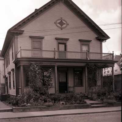 House Photograph with cover porch and upper deck.
