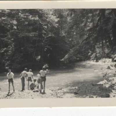 7 Persons Standing by a creek
