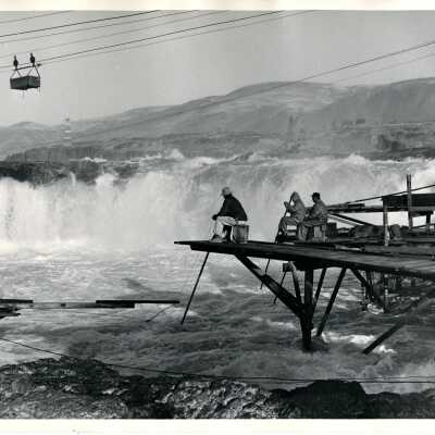 Photograph of two men fishing off platform at Celilo Falls prior to inundation in 1957 - 1945 - Black and White