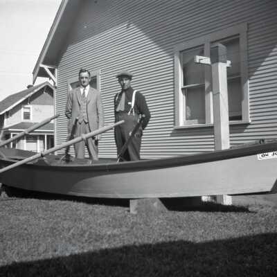 William Krueger and H.C. Frisbie with Rowboat in Yard. Photo #1.
