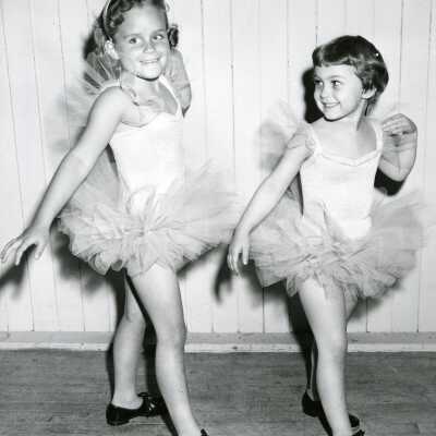 Two dancing Girls in Tutus and Tap Shoes.