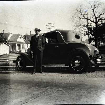 Man with Car at Street Corner.
