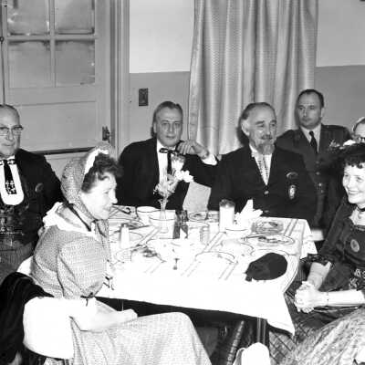 Men and Women in Period Clothing Dining