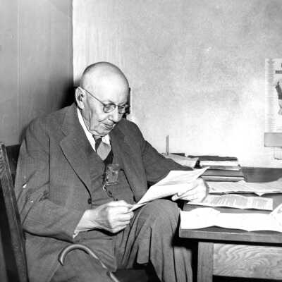 Burt Brown Barker at Desk.