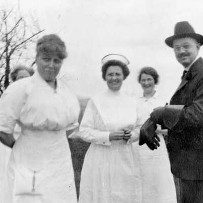 Dr. Frank Mount with His Wife and Three Nurses.