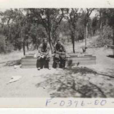 Fort Lewis - Two Unknown Men on Stack of Lumber