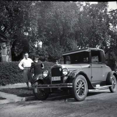 Man and Woman with Car in Front of House, 2.