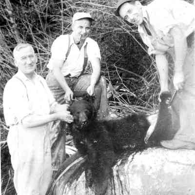 4944 - Three men with bear carcass.tif