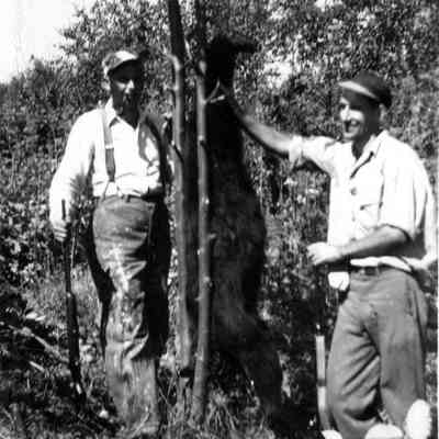 4943 - Two men with bear carcass.tif