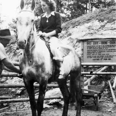Eileen McLellan and Riding Academy sign