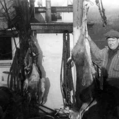4854 - Man on boat with hunted deer 1945.tif