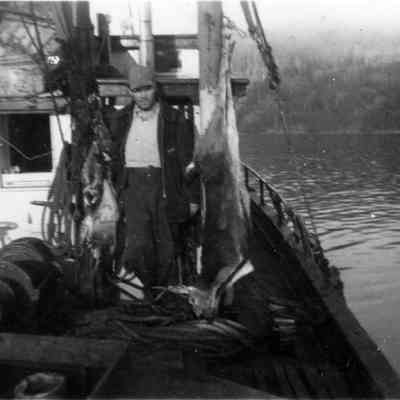 4828 - Man on boat with hunted deer 1945.tif