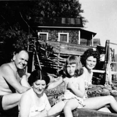 Downie Kirk family outside squatters' shacks, Cates Park