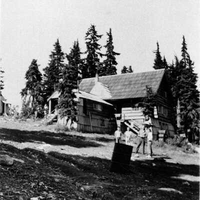 Stirrat, Reta and Bob by old car on Seymour Mtn.
