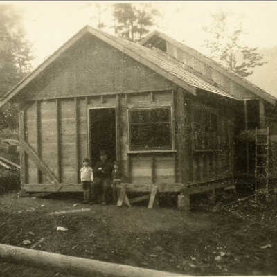 Moore, John Sr in front of 2nd store