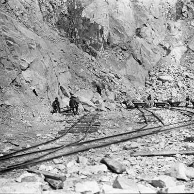 Granite Quarries Ltd -men piling rocks on flatbed (horizontal)