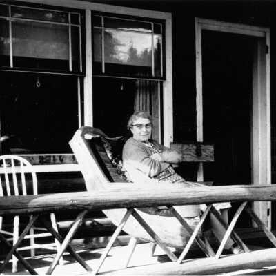 Gillis, Mrs Christena on porch of Homestead