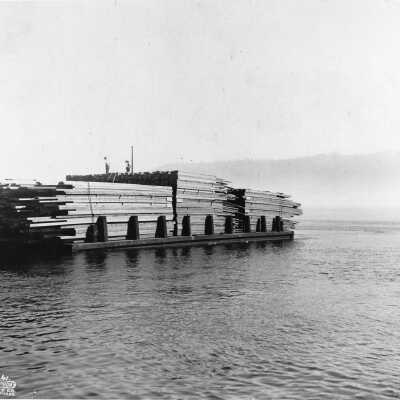 Dollar Mill Stacked lumber on barge