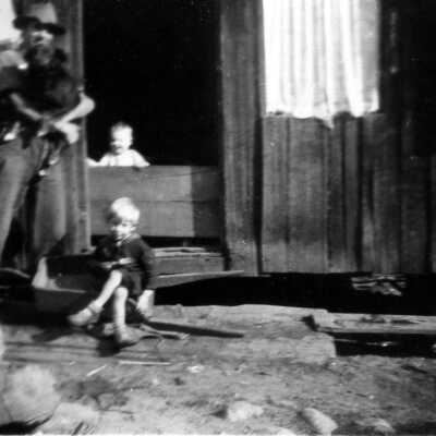 Man with children in front of store