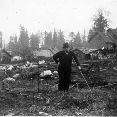 Mr. Moore in front of 2nd house