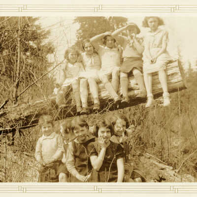 Ten Roche Point Students on a log.