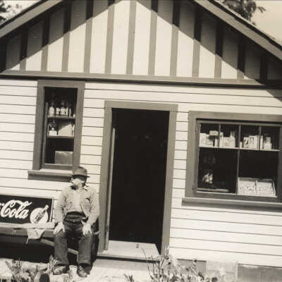 Moore, John Sr in front of his store