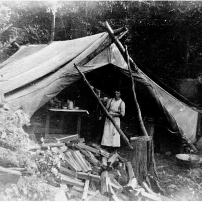Young man in front of cook's tent
