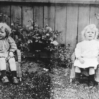 Two young girls on wicker chairs