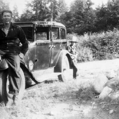 John Moore leaning on front of car