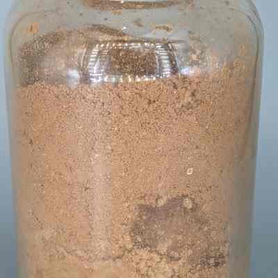 A fully glass jar containing the roasted and ground shells of cacao