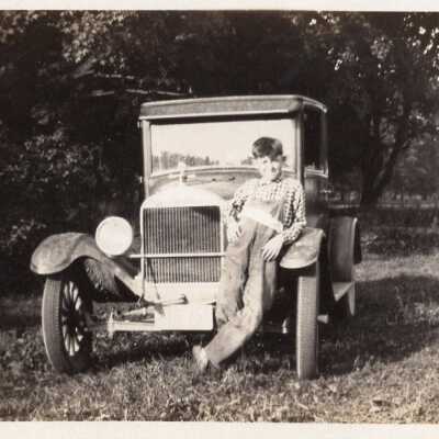 Boy Leaning on Automobile