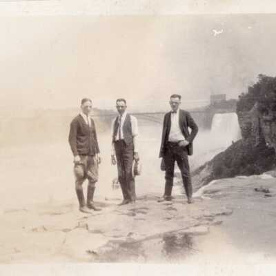 Three Men in Front of Waterfall