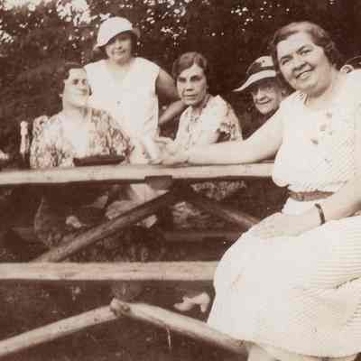 Ladies Sitting At Picnic Table