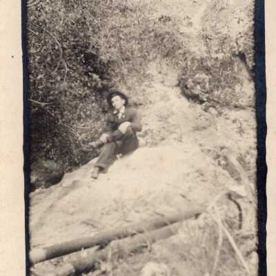 Man Sitting On Rock