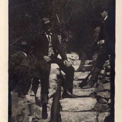 Men Standing On Stone Stairs