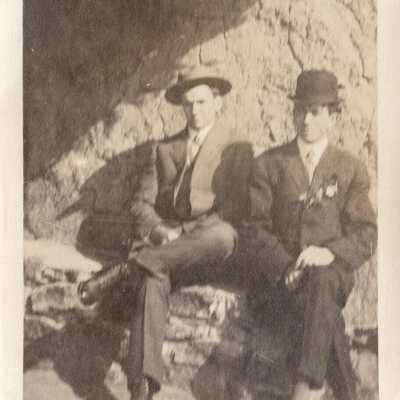 Two Men Sitting On Stone Bench