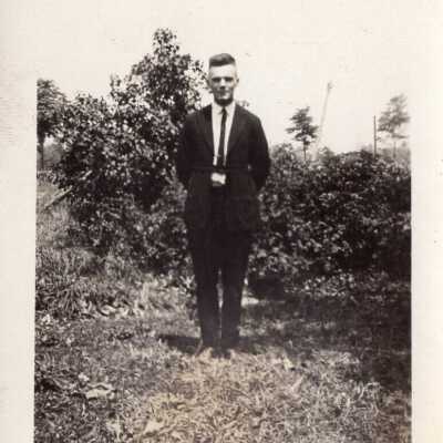 Man Standing Among Foliage
