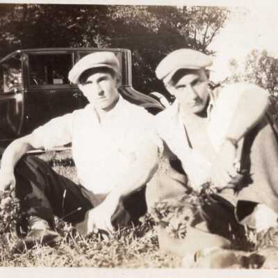 Two Men Sitting in Field
