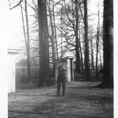 Man By Outhouse